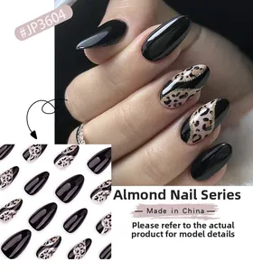 Almond press-on nails with leopard print, black finish, and gold glitter accents