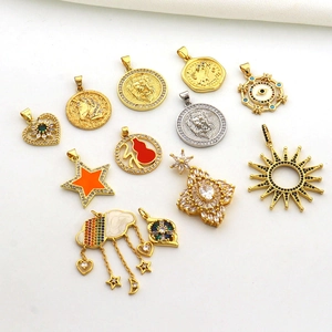 Flat lay of 12 mixed gold and silver pendants with zircon and enamel details