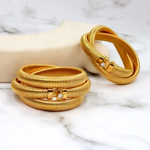 Macro shot of gold Tubogas spiral bracelet featuring a sparkling round zircon stone