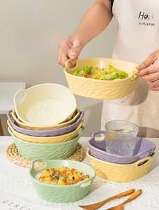 Detailed view of macaron colored ceramic bowls with textured ripples and side handles