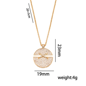 Gold round cross necklace with sparkling crystals and detailed dimensions on white background