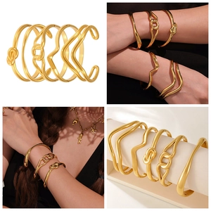 Detailed close-up of 5-piece 18k gold plated stainless steel knot bracelet set