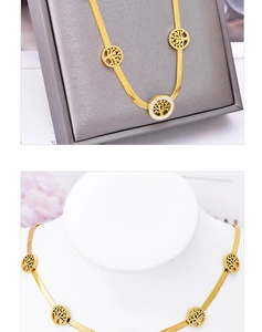 Macro detail of gold Tree of Life pendant with zircon micro-paving on a snake chain