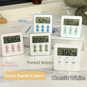 Five magnetic digital visual timers in candy colors on white book and marble desk