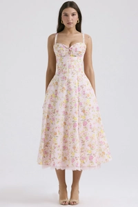 Detail of floral summer dress with lace trim and delicate pink flower patterns