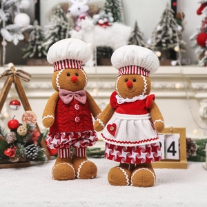 Gingerbread man plush dolls in chef outfits with Christmas tree background for home decor