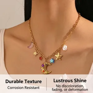 Close-up of bohemian gold plated necklace featuring colorful moon and sun charms