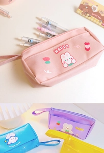 Detail of colorful canvas pencil cases with cute cartoons and HAPPY text embroidery
