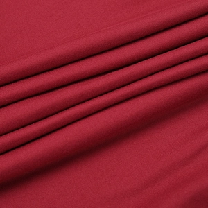 Close-up of deep red knit fabric showing premium texture and soft mesh stitching detail