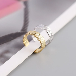 Detailed macro view of irregular foil texture on S925 sterling silver open rings