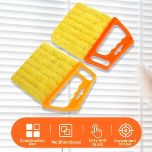 Detail of orange blind cleaner brush with microfiber sleeves cleaning white window shutters