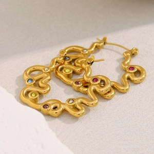 Detailed shot of 18K gold plated wave earrings with vibrant multi-color zircon stones