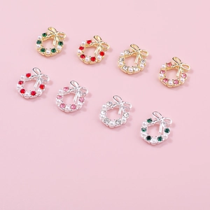 Detailed view of Christmas wreath nail charms with pearls, rhinestones and bowknots
