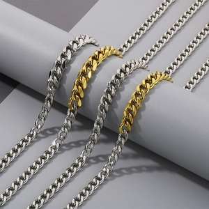 Silver and two-tone gold Miami Cuban link bracelets displayed on a minimalist gray stand