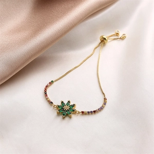 Detail of adjustable gold flower bracelet with green zircon and colored crystals