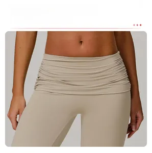 Detail view of high-waisted yoga flared pants featuring no-front-seam and waist folds
