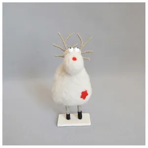 Detail of wool felt reindeer ornament with red star and rustic wooden base for Christmas