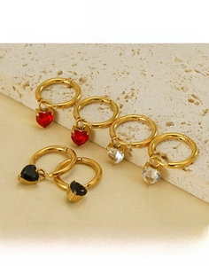 Detailed view of heart-shaped zircon drop earrings in red, white, and black titanium steel