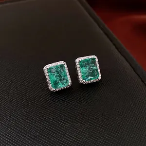 Elegant emerald cut green zircon halo stud earrings with polished silver metal setting