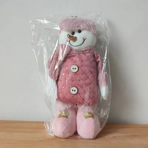 Detailed view of a pink plush Christmas snowman doll in a stylish sequined coat and hat