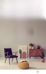 Minimalist grey wall clock with 3D white numerals in a modern living room setting