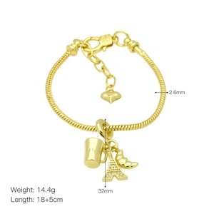 Detailed view of 18k gold plated bracelet with coffee cup and Eiffel Tower charms