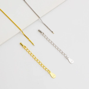 Detailed close-up of S925 sterling silver box chain bracelets in gold and silver finishes