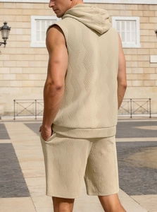 Outdoor back view of men's sleeveless hooded tracksuit with textured knit fabric