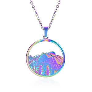 Macro shot of circular rainbow stainless steel pendant with mountain and tree landscape