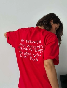 Close-up of quote print on the back of a bright red oversized cotton t-shirt