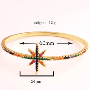 Detailed view of 18k gold plated oval bangle with colorful zircon star showing 60mm diameter