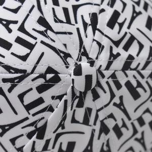 Macro detail of houndstooth baseball cap showing high-quality stitching and fabric texture