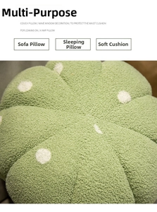 Close-up of green polka dot bouclé pumpkin pillow with soft textured fabric finish