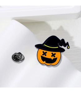 Detail shot of Halloween pumpkin brooch with wizard hat on white stone base