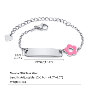 Macro detail of stainless steel bar bracelet with pink flower and adjustable heart charm