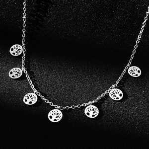 Detail of silver stainless steel necklace featuring six hollow tree of life pendants