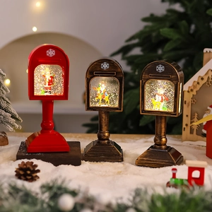 Three vintage Christmas mailbox snow globes with Santa figures and warm glowing lights