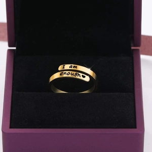 Close-up of golden S925 ring with I am enough engraving in a luxury jewelry gift box