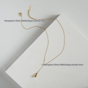 Close-up of minimalist 18K gold plated Y-necklace with elegant double teardrop pendants