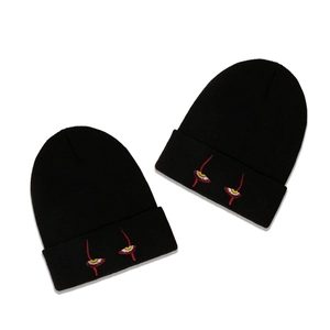 Black knitted beanies featuring unique eye embroidery in a minimalist street style