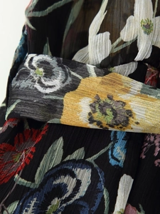 Close-up of pleated floral embroidery on black fabric for a midi summer sundress