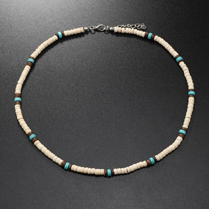 Detail of bohemian beaded necklace with turquoise stones and wooden spacers on dark grey