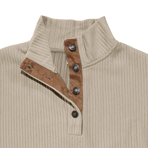 Detail of ribbed beige sweatshirt with faux suede trim and metallic snap buttons
