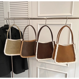 Detail of four suede tote bags with white faux fur trim in olive, brown, and ginger