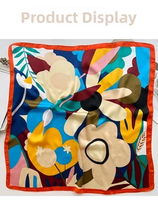 Detail showing high-quality satin square scarf with abstract floral print and orange edges