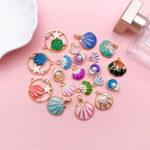 Flat lay of colorful enamel shell and round alloy pendants for DIY jewelry making