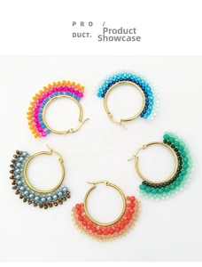 Detailed flat lay of five colorful beaded hoop earrings in rainbow and blue tones