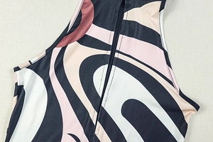 Detail of invisible zipper and geometric spiral print on the elastic bodysuit fabric