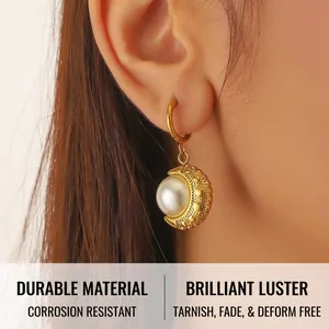 Detail of baroque pearl earring with heart-embossed gold base on person
