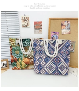 Detail of embroidered canvas tote bags with ethnic floral patterns and rope handles